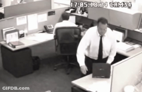 A Black And White Photo Of A Man In A Cubicle With Cam34 Written On The Bottom Right GIF