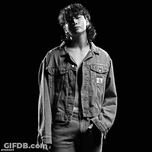 A Black And White Photo Of A Man In A Denim Jacket GIF