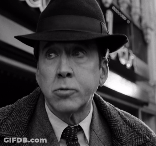 A Black And White Photo Of A Man In A Hat GIF