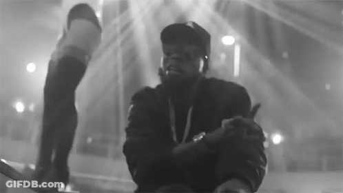 A Black And White Photo Of A Man In A Hat Giving A Thumbs Up GIF