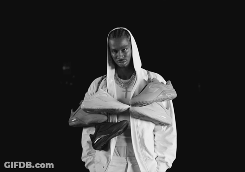 A Black And White Photo Of A Man In A Hooded Jacket GIF