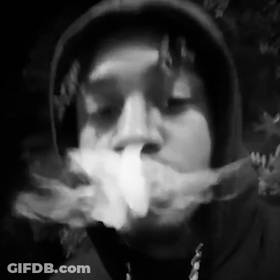 A Black And White Photo Of A Man In A Hoodie Smoking A Cigarette . GIF