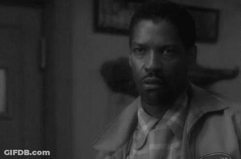A Black And White Photo Of A Man In A Jacket GIF