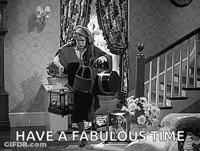A Black And White Photo Of A Man In A Living Room With The Words `` Have A Fabulous Time '' Written On It . GIF