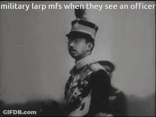 A Black And White Photo Of A Man In A Military Uniform GIF