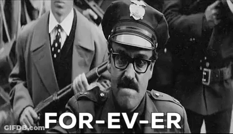 A Black And White Photo Of A Man In A Police Uniform Holding A Gun . GIF