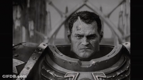 A Black And White Photo Of A Man In A Robot Costume Looking At The Camera . GIF