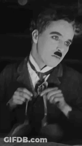 A Black And White Photo Of A Man In A Suit And Tie . GIF