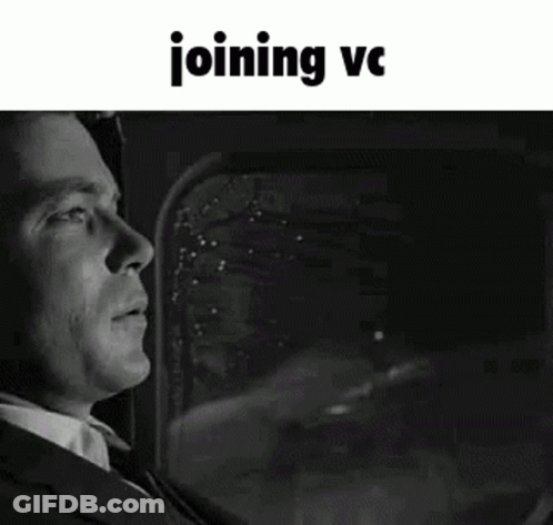 A Black And White Photo Of A Man In A Suit And Tie Looking Out A Window . GIF