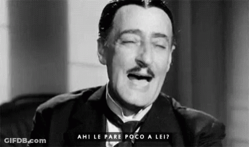 A Black And White Photo Of A Man In A Suit And Tie With His Eyes Closed And The Words Ahi Le Pare Poco A Lei GIF