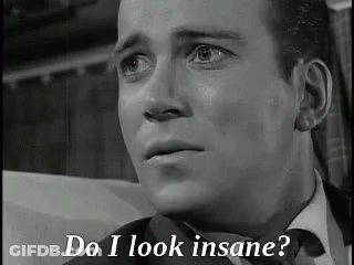 A Black And White Photo Of A Man In A Suit And Tie With The Words `` Do I Look Insane '' Written Below Him . GIF