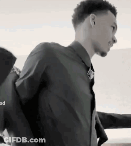A Black And White Photo Of A Man In A Suit GIF