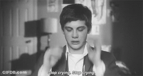 A Black And White Photo Of A Man In A Suit With The Words `` Stop Crying , Stop Crying '' Written On It . GIF