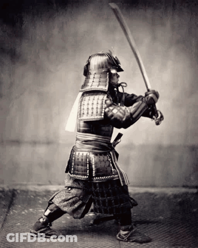 A Black And White Photo Of A Man In Armor Holding A Sword GIF