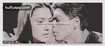 A Black And White Photo Of A Man Kissing A Woman . GIF