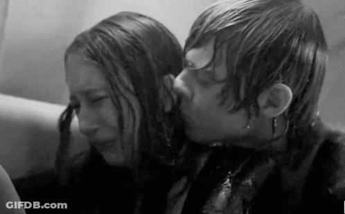 A Black And White Photo Of A Man Kissing A Woman In A Bathtub . GIF