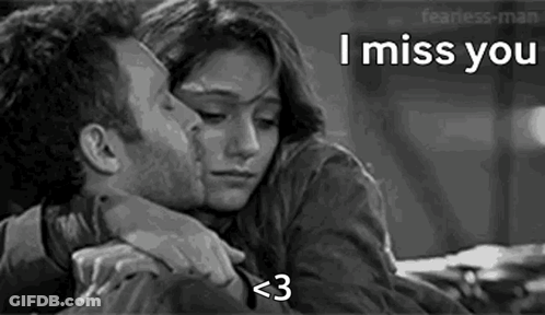 A Black And White Photo Of A Man Kissing A Woman On The Forehead . GIF