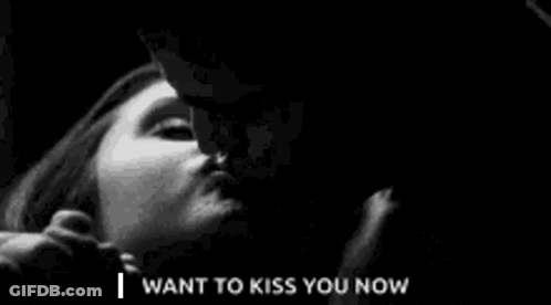 A Black And White Photo Of A Man Kissing A Woman . GIF