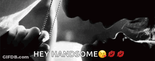 A Black And White Photo Of A Man Kissing A Woman With The Words Hey Handsome Below Them GIF