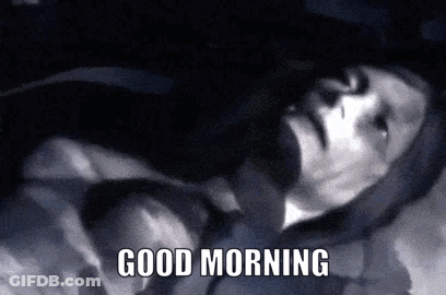 A Black And White Photo Of A Man Laying Down With The Words Good Morning Written Below Him . GIF