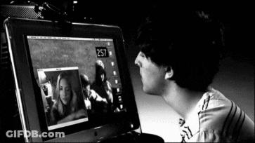 A Black And White Photo Of A Man Looking At A Computer Screen That Says 257 GIF