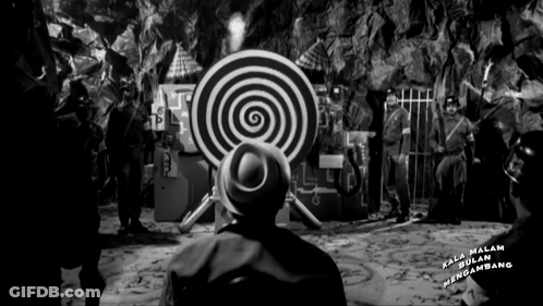 A Black And White Photo Of A Man Looking At A Target That Says Kala Malam Mengambang On It GIF