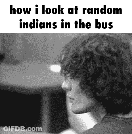 A Black And White Photo Of A Man Looking At Random Indians In The Bus . GIF