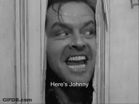 A Black And White Photo Of A Man Looking Through A Door With The Words `` Here 'S Johnny '' Written Below Him . GIF