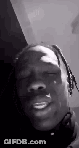 A Black And White Photo Of A Man Making A Funny Face . GIF