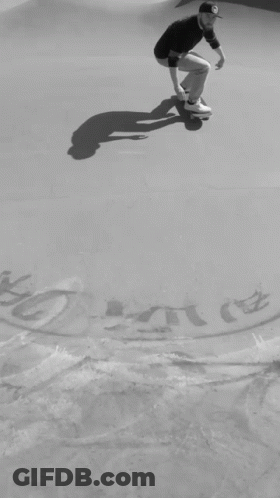 A Black And White Photo Of A Man On A Skateboard With A Drawing Of A Key And A Skateboard On The Ground GIF