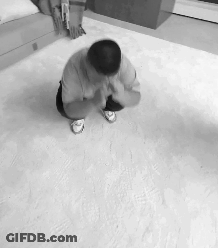 A Black And White Photo Of A Man On His Knees GIF