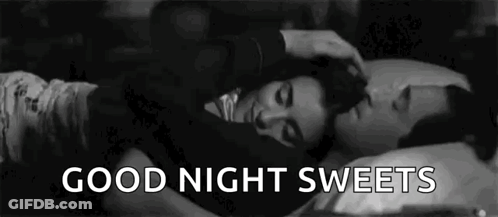 A Black And White Photo Of A Man Petting A Woman 'S Head While They Sleep . GIF