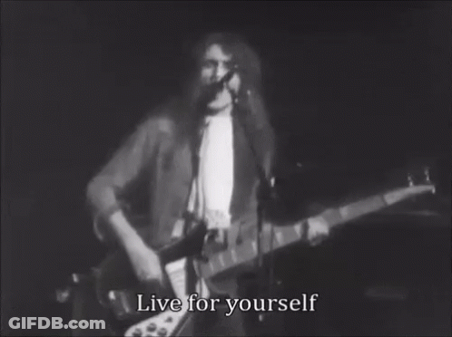 A Black And White Photo Of A Man Playing A Guitar And Singing Into A Microphone With The Words Live For Yourself . GIF