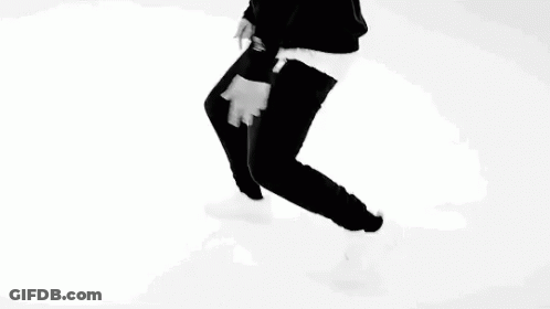 A Black And White Photo Of A Man Pointing At His Chest . GIF