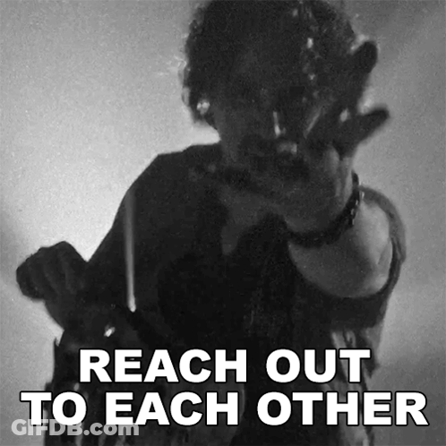 A Black And White Photo Of A Man Pointing With The Words Reach Out To Each Other GIF