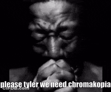 A Black And White Photo Of A Man Praying With His Hands Folded In Front Of His Face . GIF