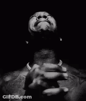A Black And White Photo Of A Man Praying With His Hands Folded In Prayer . GIF