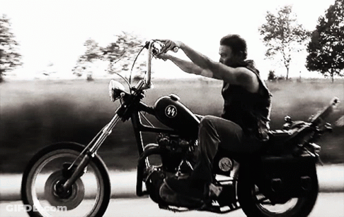 Black And White Photo Of Man Riding Chopper GIF