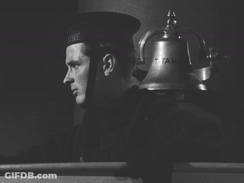 A Black And White Photo Of A Man Ringing A Bell That Says Titanic GIF