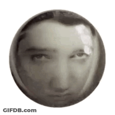 A Black And White Photo Of A Man 'S Face In A Circle . GIF
