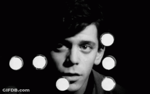 A Black And White Photo Of A Man 'S Face Surrounded By Circles . GIF