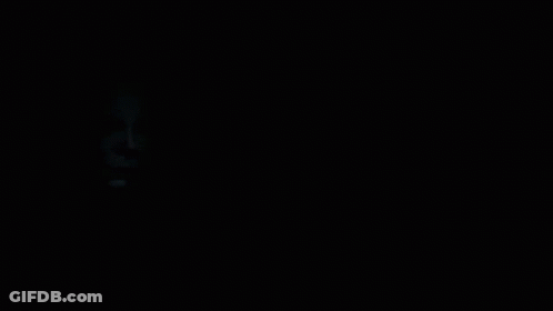 A Black And White Photo Of A Man 'S Face With A White Mask On GIF