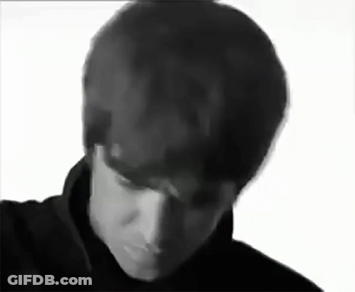 A Black And White Photo Of A Man 'S Face With His Eyes Closed . GIF