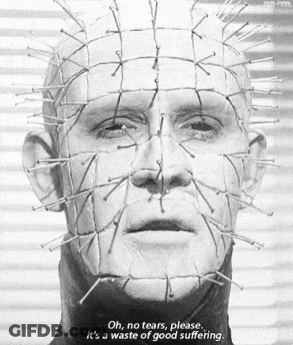 A Black And White Photo Of A Man 'S Face With Nails On It . GIF