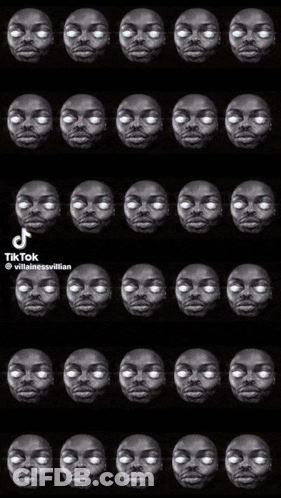 A Black And White Photo Of A Man 'S Face With White Eyes And Teeth . GIF
