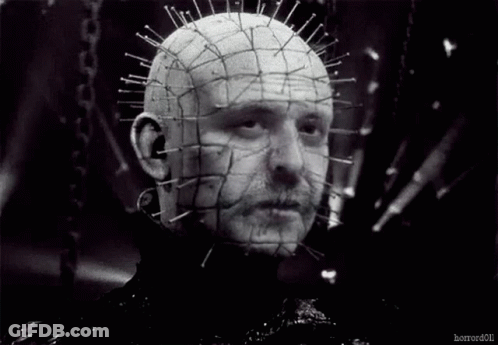 A Black And White Photo Of A Man 'S Head With Pins In It . GIF