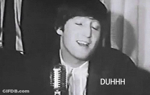 A Black And White Photo Of A Man Singing Into A Microphone With His Eyes Closed . GIF