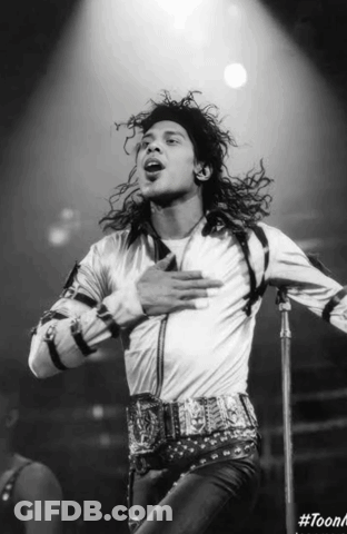 A Black And White Photo Of A Man Singing Into A Microphone With The Hashtag #Toonk GIF