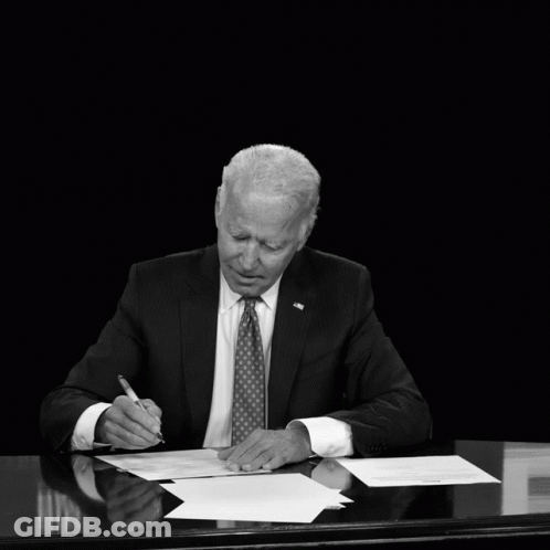 Black And White Photo Of Man At Desk With Biden Deficit Text GIF