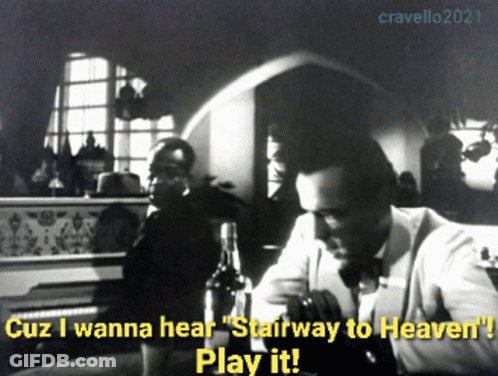 A Black And White Photo Of A Man Sitting At A Table With Stairway To Heaven Written On It GIF